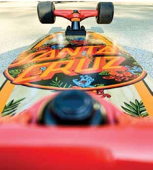Close up of the bottom of a brightly decorated skateboard.