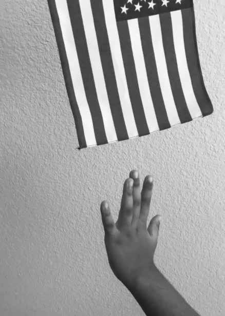 Young hand reaches for a hanging flag