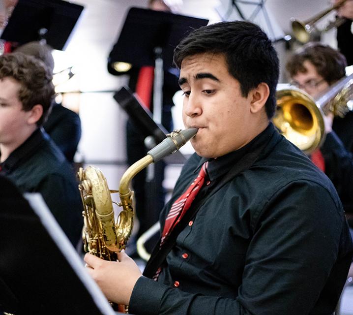 Close-up of sax player behind music stand