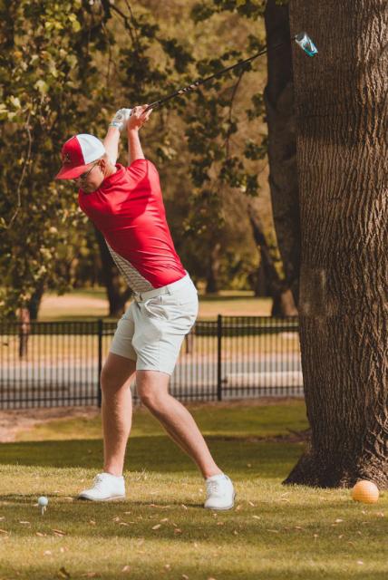 Benbrook on golf course mid swing