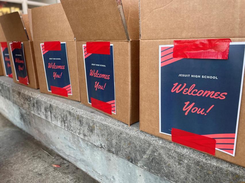 shelf full of brown boxes with cheerful welcome labels
