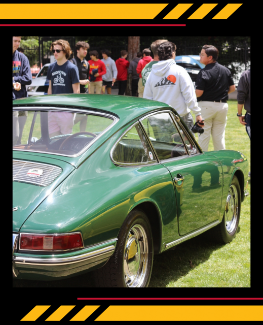 image of back of a vintage green Porsche with students milling around it on a sunny day