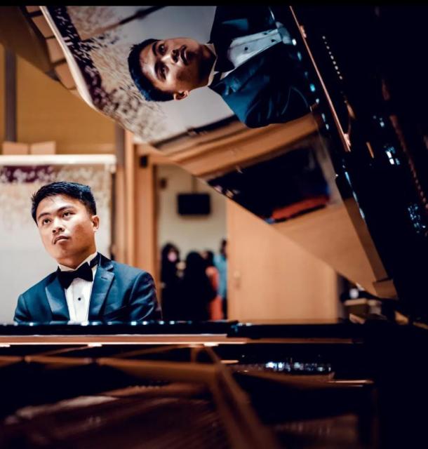 Castaneda's reflection caught in piano lid playing at Vienna