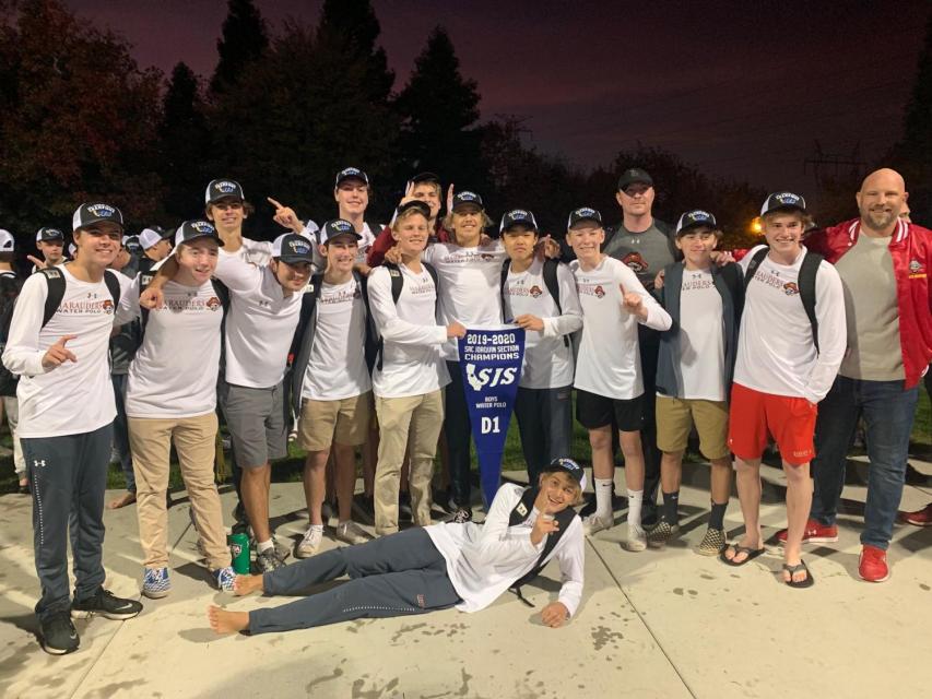 Group shot of water polo team holding pennant