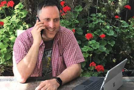 Image of VP Farr on phone in backyard