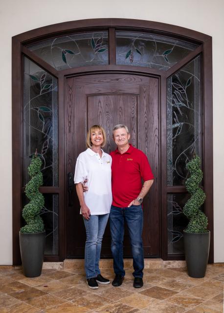 Image of Tim and Mary Frances Jeffries smiling in front of a stately door