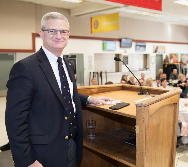 Man smiling  at podium.