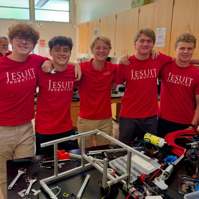 Robotics team by the pool during a competition