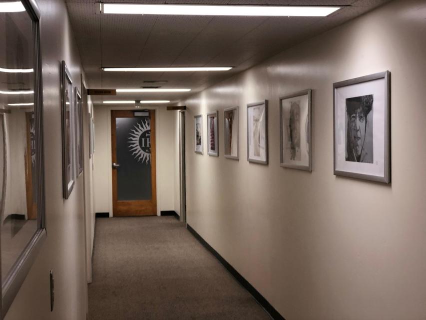 Hallway with framed prints along one side