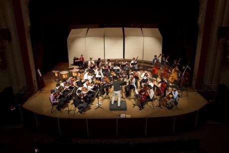 The JHS Symphony Orchestra performing on stage of the Faye Spanos Concert Hall at the University of the Pacific with Professor Nicolas Waldvogel in 2013.