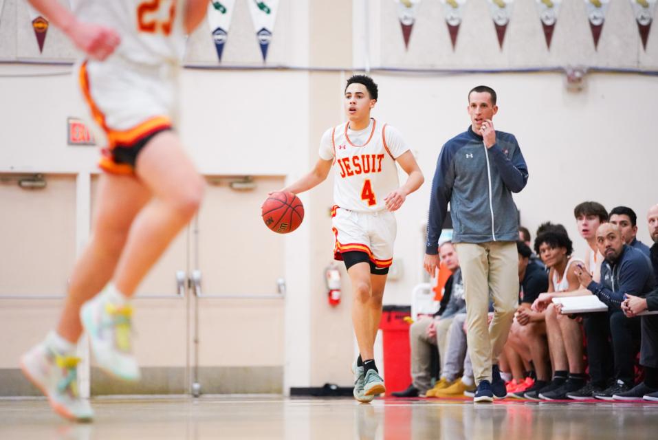 Jesuit guard Chris Holley '21 handles the ball for the Marauders