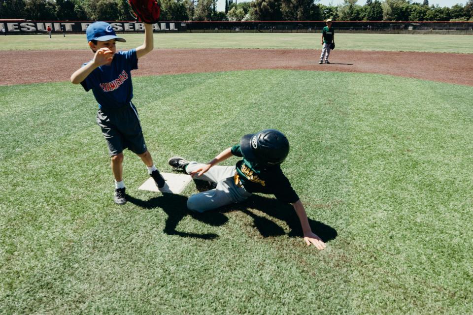 Image of camper sliding into base on a baseball diamond