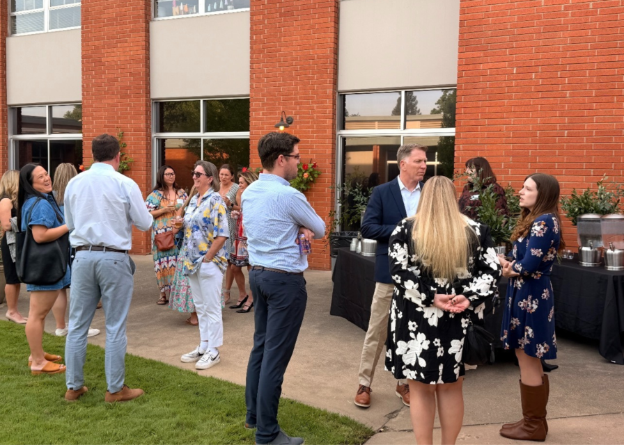 people standing and talking in a courtyard