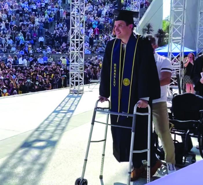 Paylor walking across grad stage