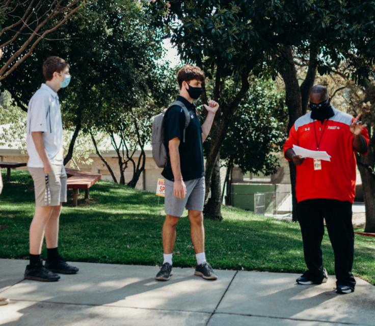 Dean Theodule leads two students in training