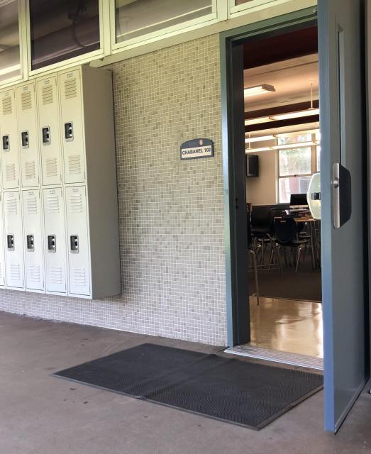 Image of an open classroom door and lockers.