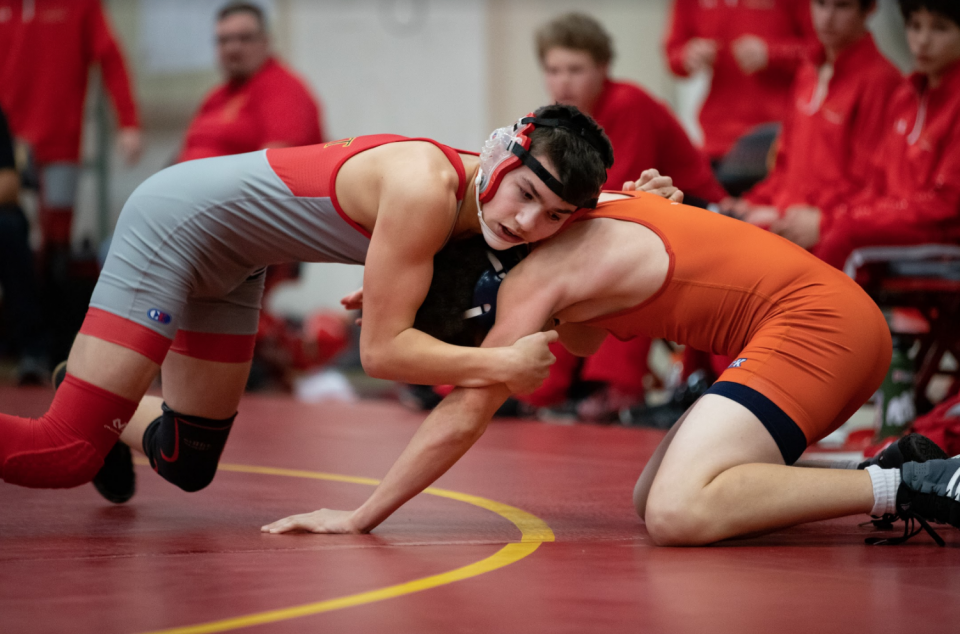 Close up of wrestlers on mat during match