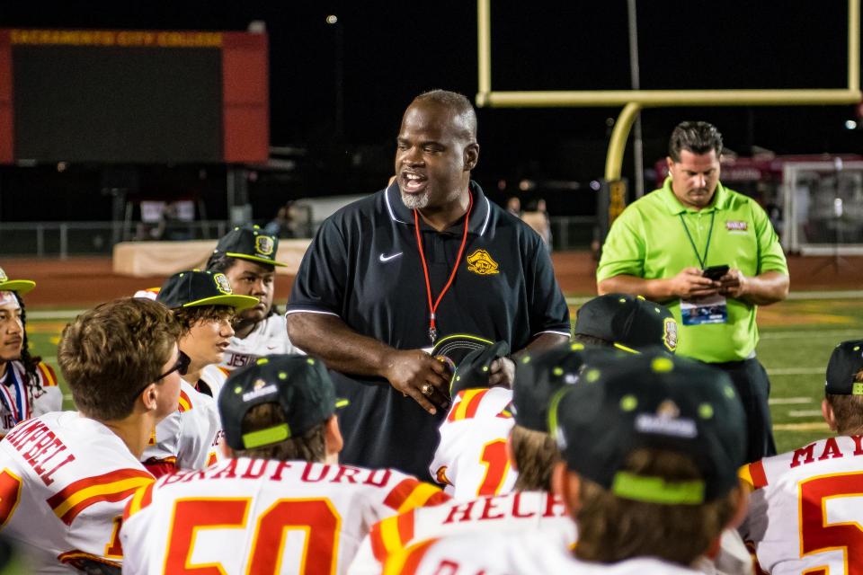 Coach Blanton speaking to Football Team after a game