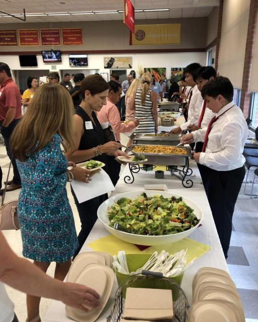 Image of parents in a buffet line during Welcome Dinner in 2019