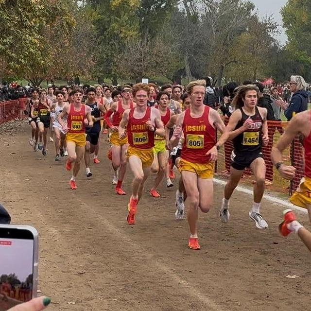 Jesuit Marauders student athletes running on the dirt cross country course