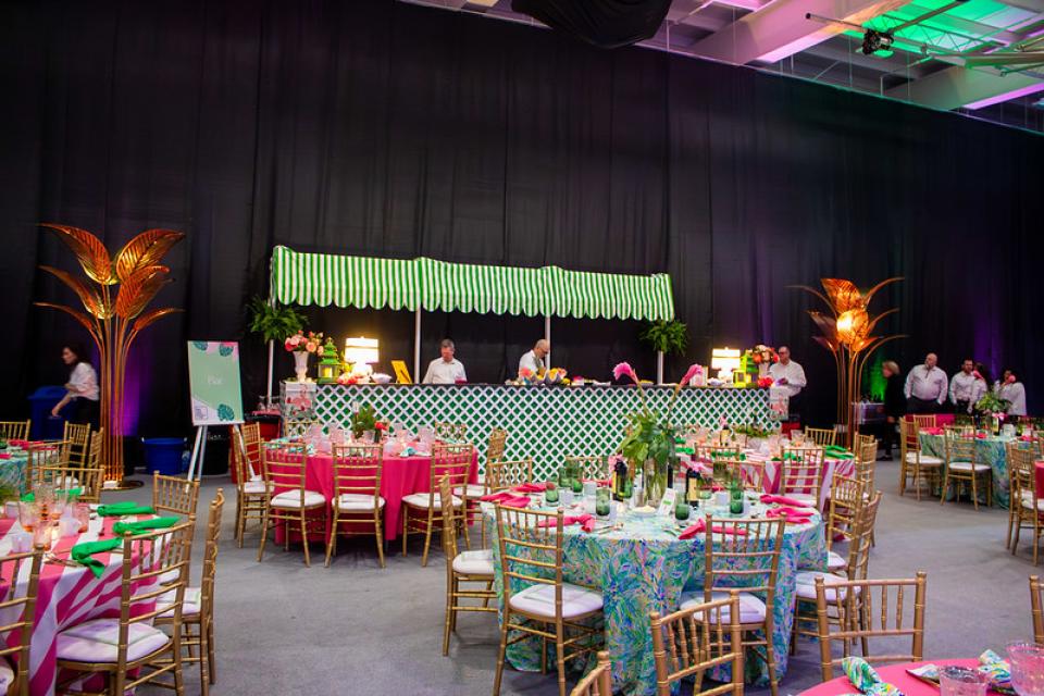 view of the bar with bartenders and volunteers standing behind in white tops and black pants