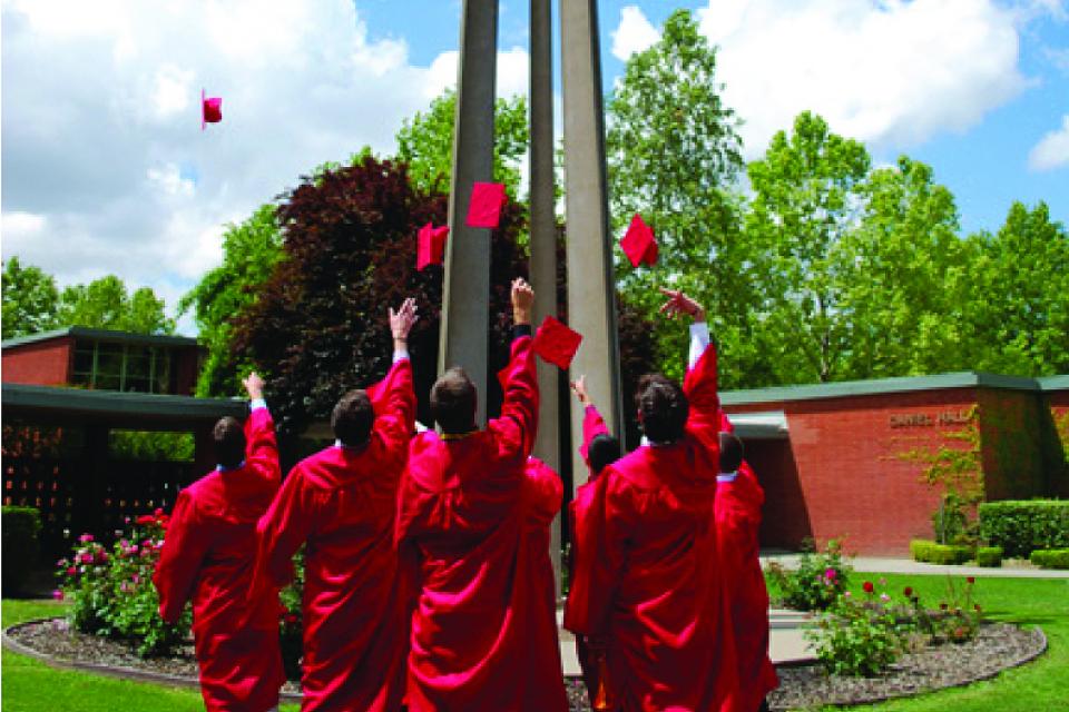 Students tossing caps around the bell tower.