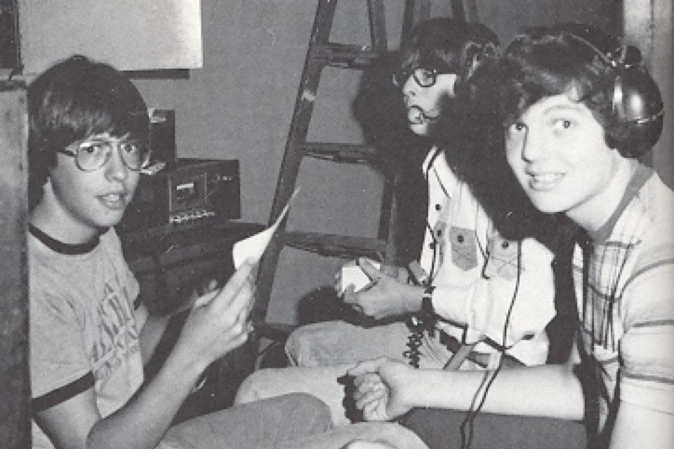 3 boys from 1977 Tech crew with headphones and scripts.