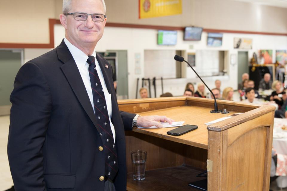 Man smiling  at podium.