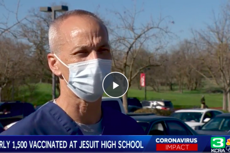 Still of interview of Dr. Rusty Oshita speaking in parking lot where vaccine clinic held 