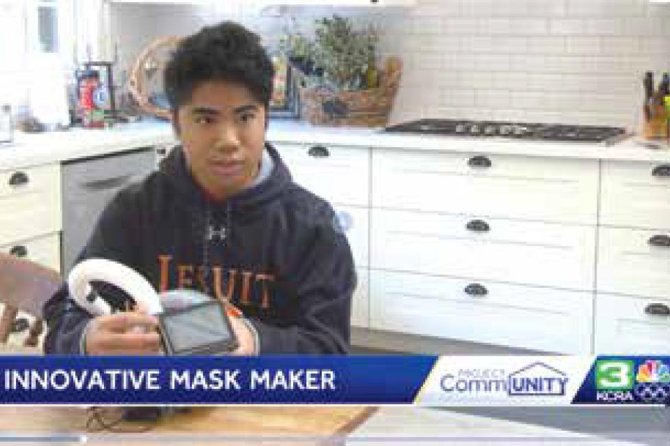 Image of student holding his modified snorkel mask