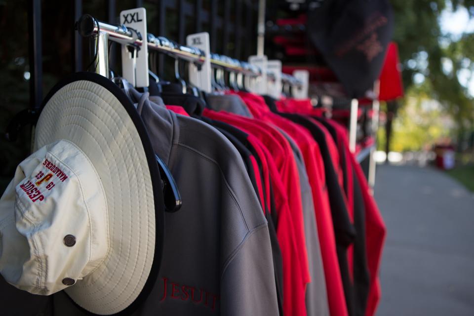 Image of shirts with logo and hat on rack in front of Marauders Cove