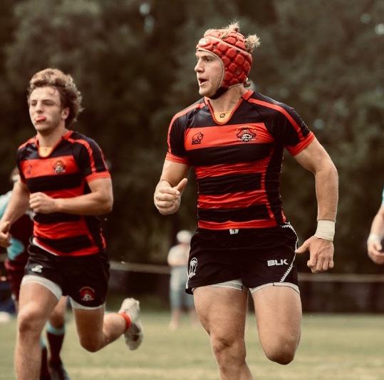 Krieger running during a rugby game with teammate