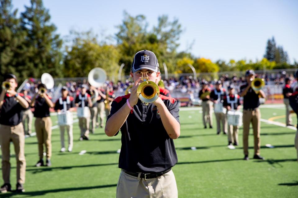 Close-up of trumpet player in formation on field