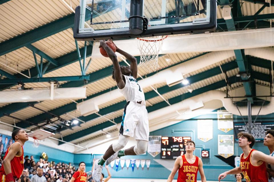 Sheldon senior guard Xavion Brown attempts a dunk in the fourth quarter of a basketball game between Jesuit and Sheldon on Saturday, Feb. 1.