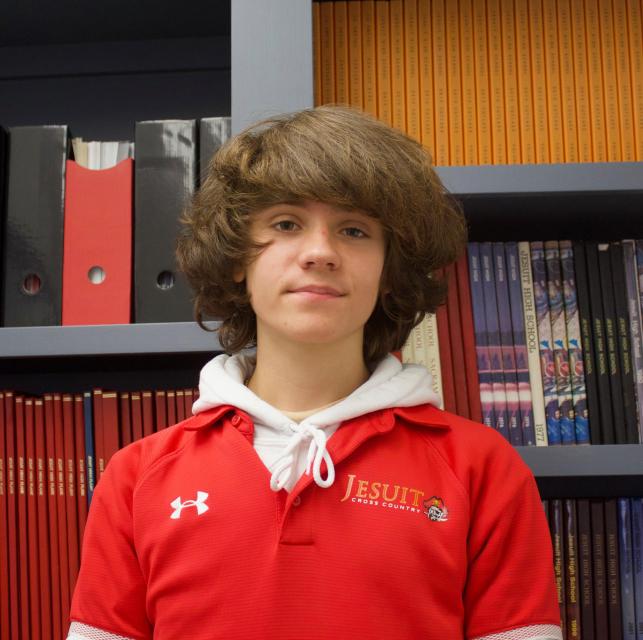 Eliot standing in front of past student publications