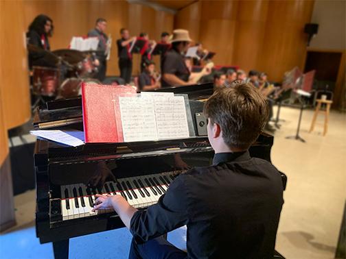 looking over piano player's shoulder at jazz band