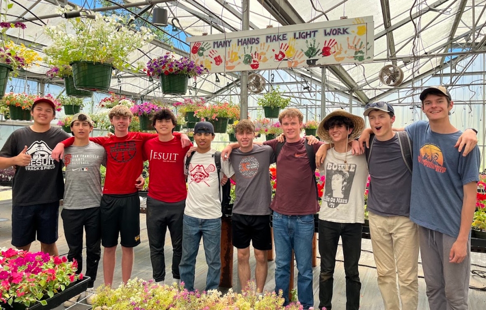 Student at L'Arche in a greenhouse