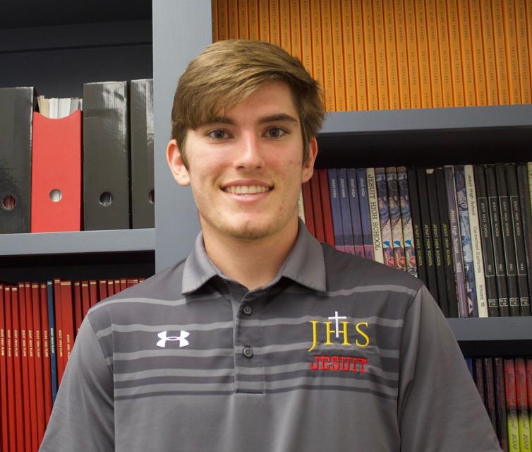 Matt standing in front of past student publications