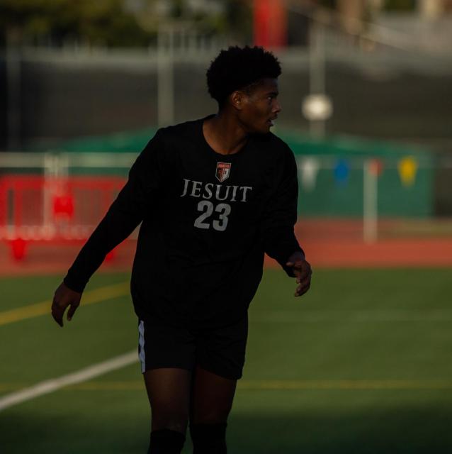 Player 23 in long sleeve shirt looking down the field.