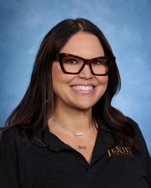 headshot of Misty with glasses smiling at camera