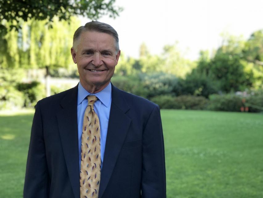 Image of Tim on campus in front of garden