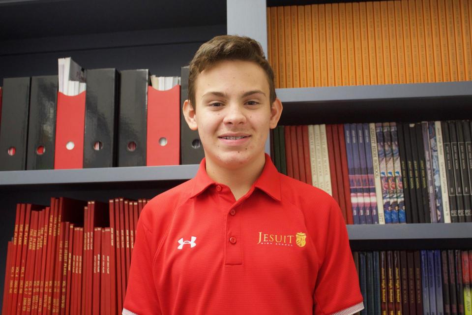 Nick standing in front of past student publications