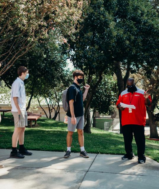 Dean Theodule leads two students in training