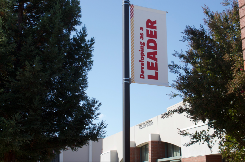 Sign on campus light pole that reads "Developing as a Leader" 