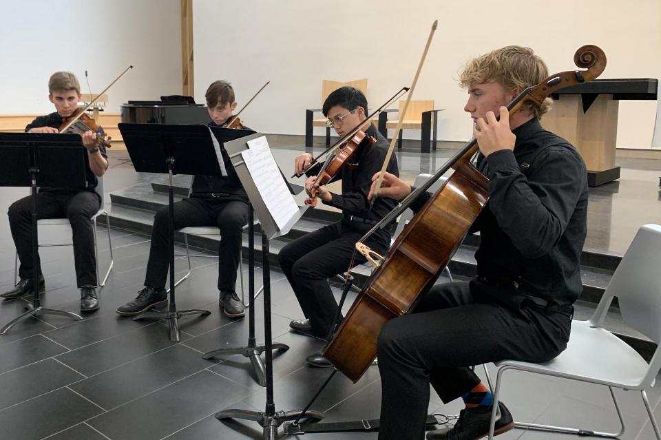 Small group of strings playing in the chapel during Open House