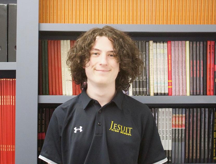 Tyler standing in front of past student publications