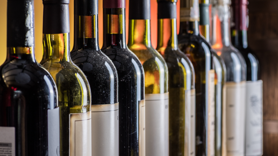row of wine bottles, red and white 