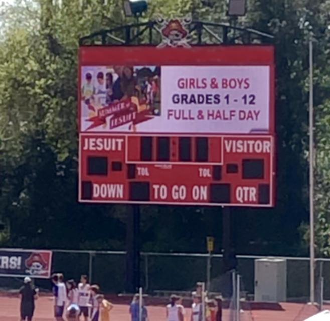 Football Stadium with digital advertising displaying on the scoreboard